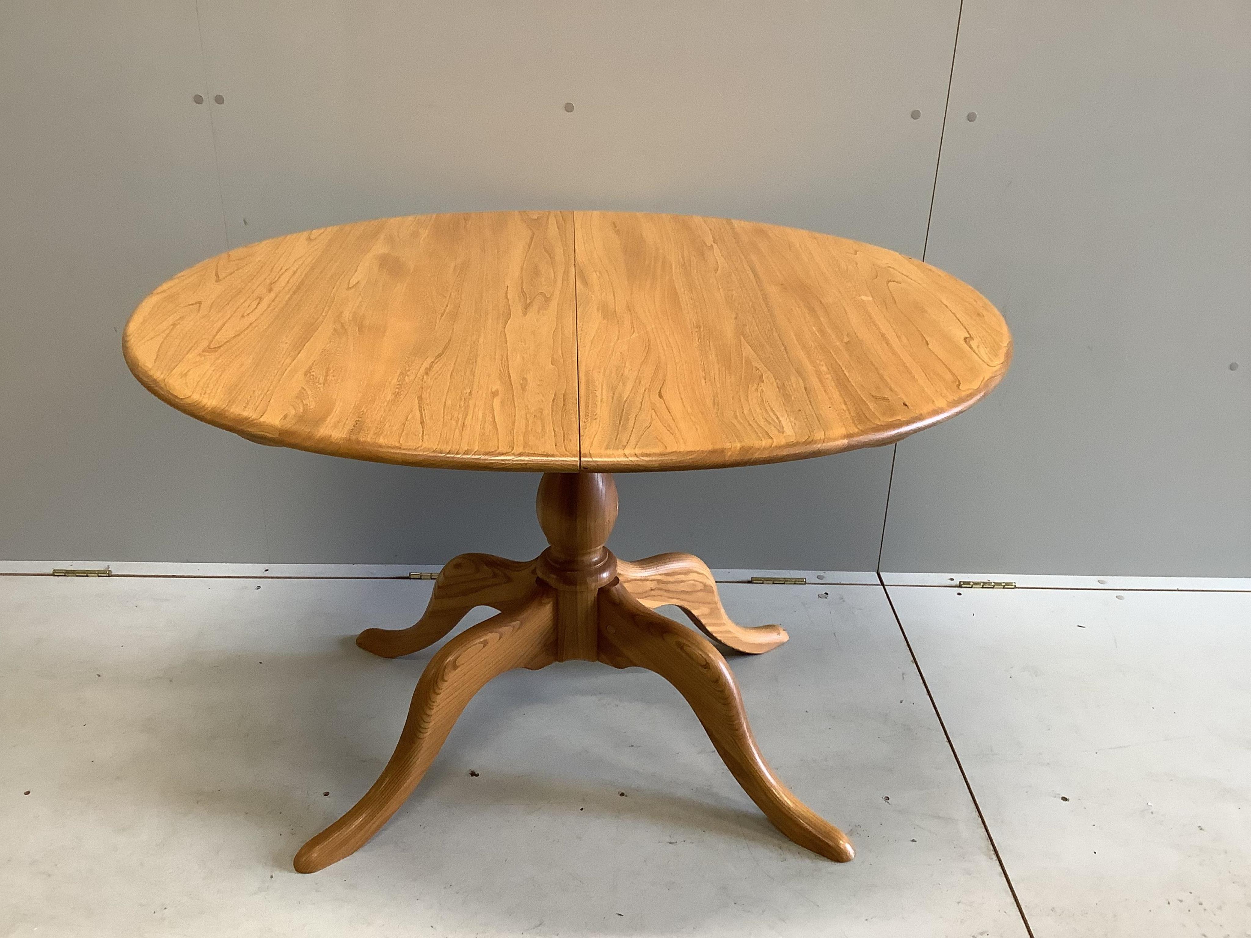 A modern Ercol elm dining table, width 110cm, depth 98cm, height 72cm (lacks spare leaf). Condition - good